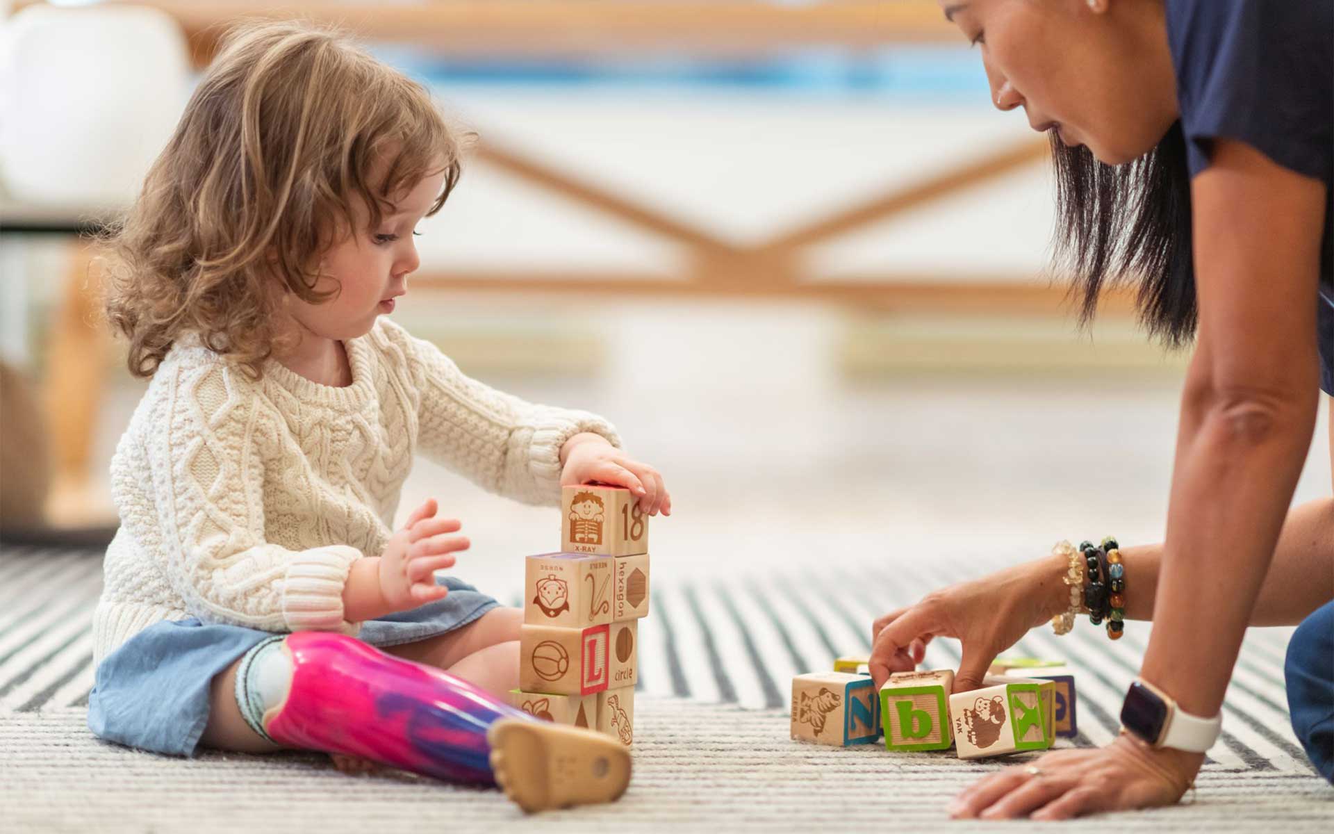 A disabled girl playing with a nurse