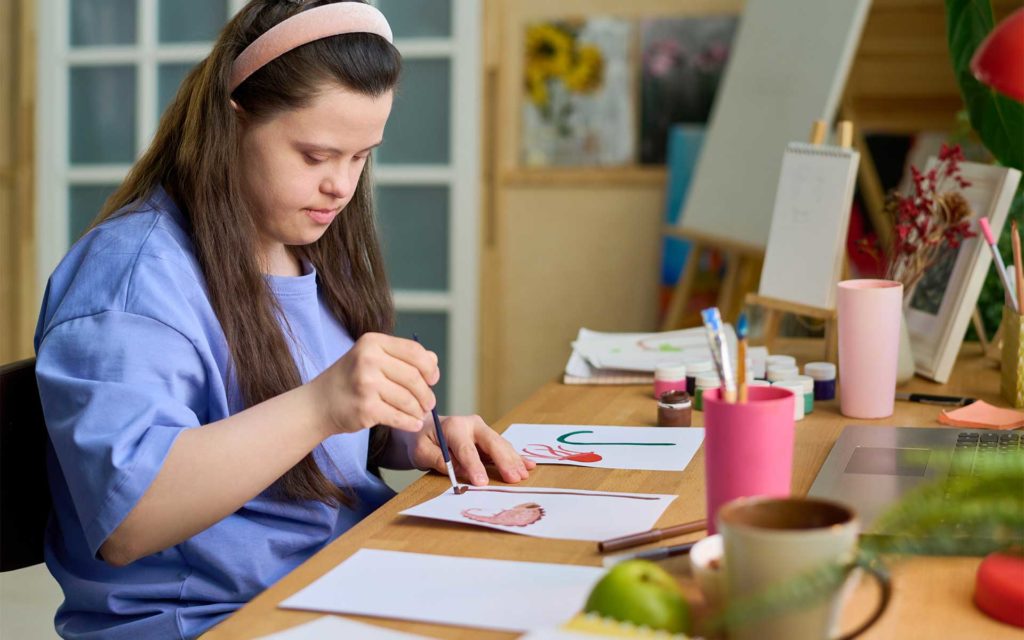 Girl with disability painting