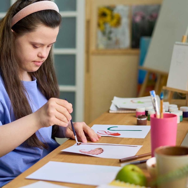 Girl with disability painting