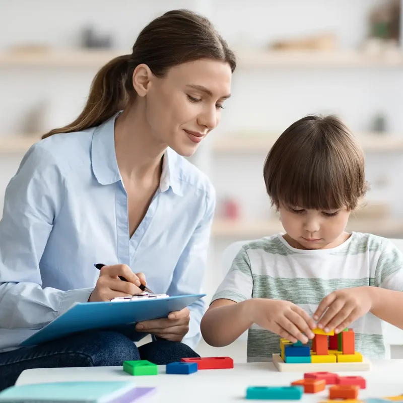 a teacher assessing child's motor skills