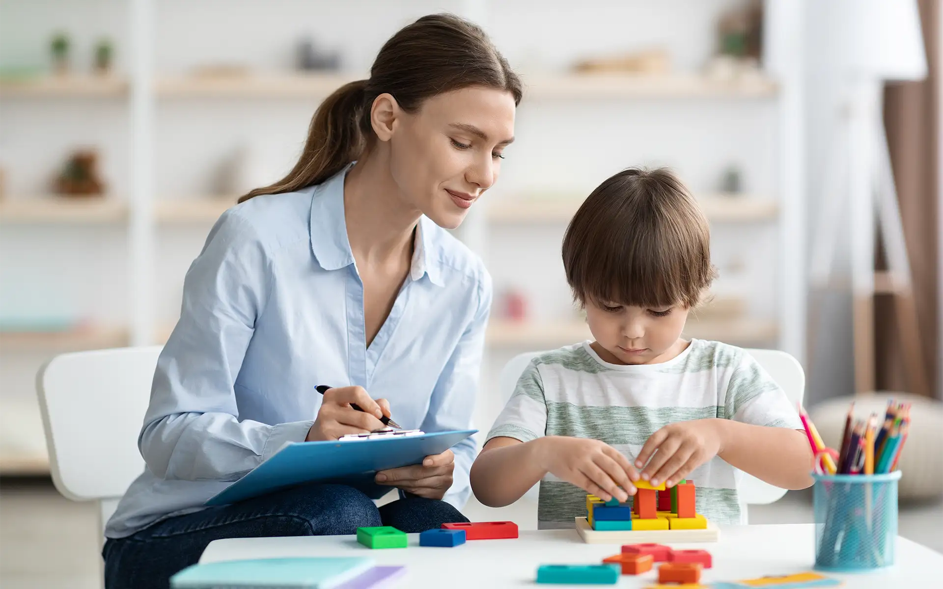 a teacher assessing child's motor skills