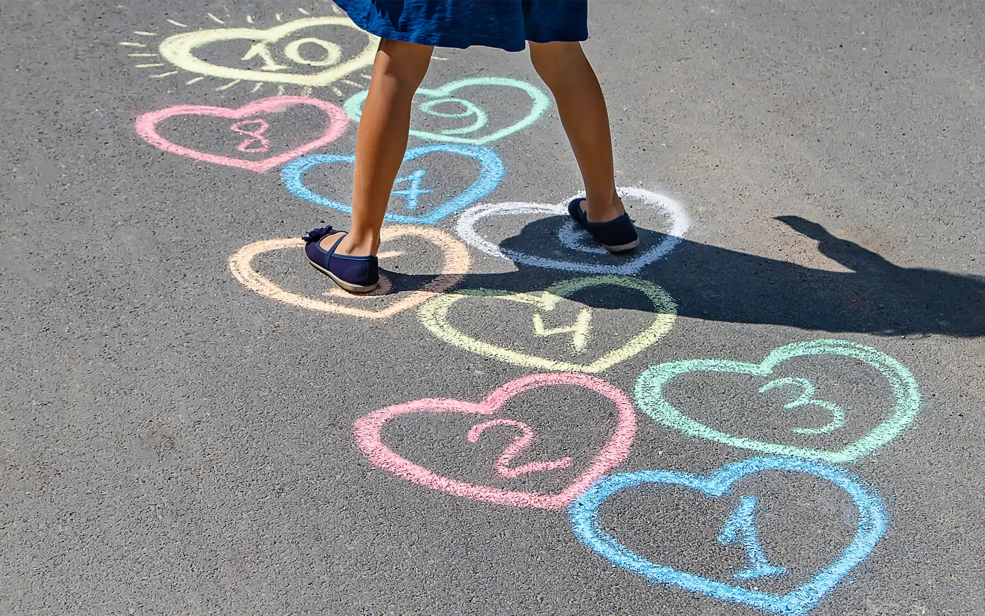 a girl playing hopscotch