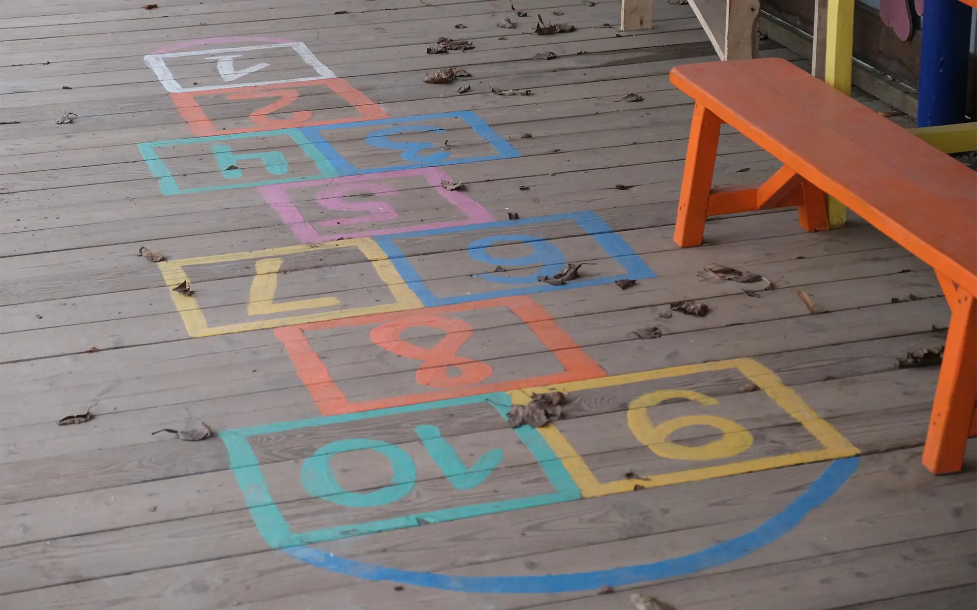colorful hopscotch squares on a wooden floor for kids' balancing exercise